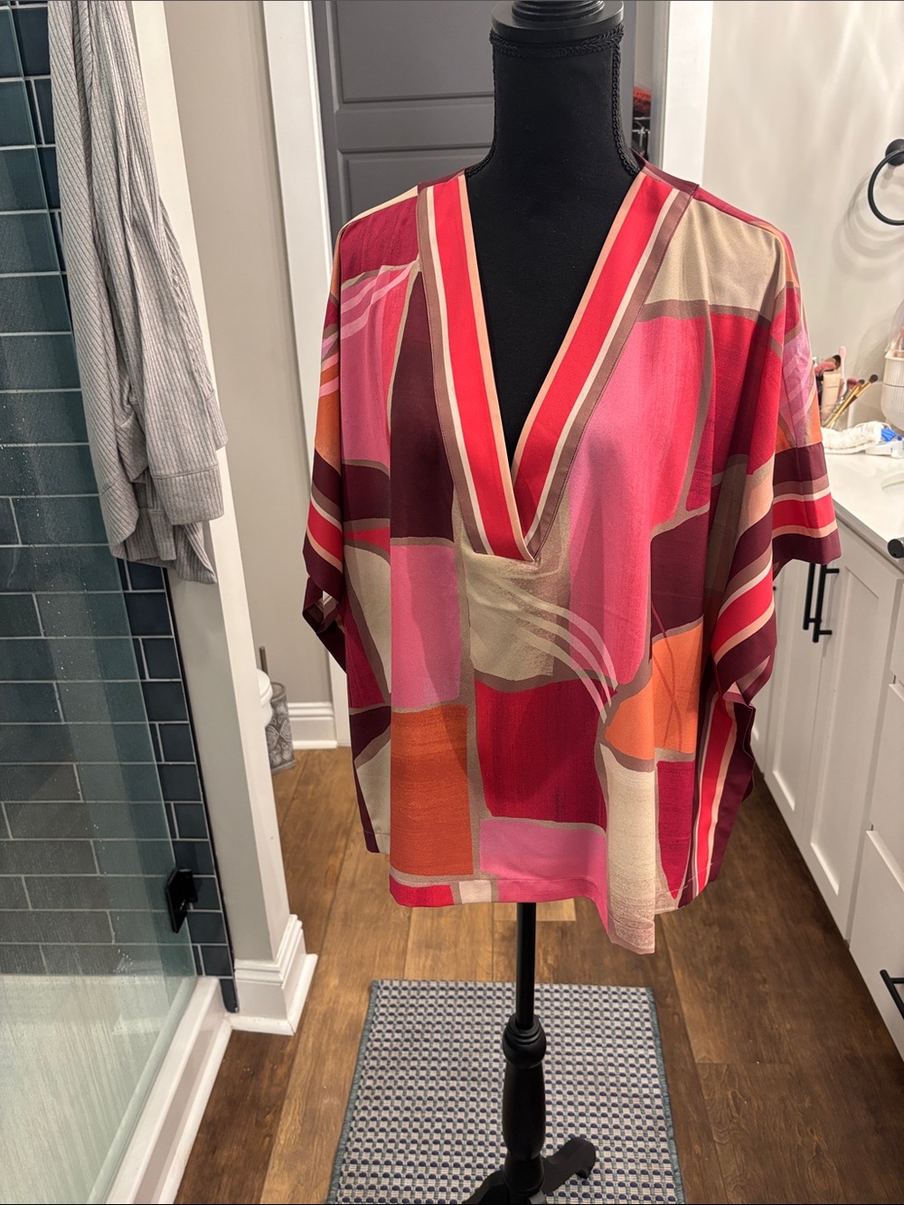 Vibrant Geometric V-Neck Blouse in Pink & Red. This is a poncho top.